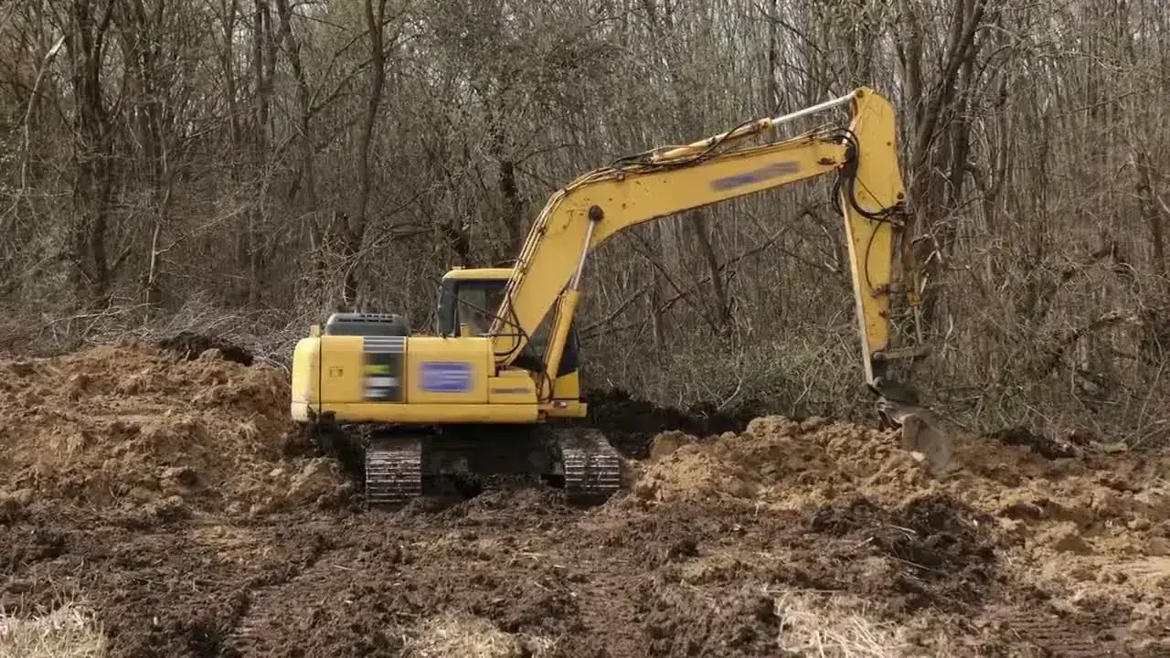 Gelber Bagger beim Aushub auf einem Grundstück